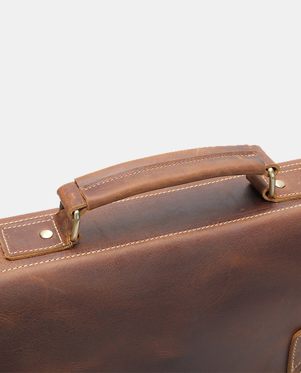 Close-up of the handle on the brown leather Anchor Messenger Bag for men.