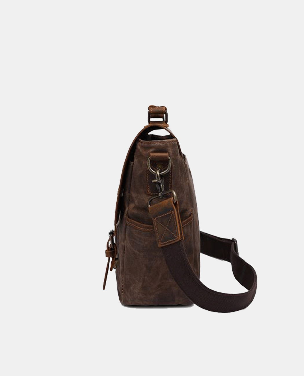 Side view of brown canvas messenger bag with leather flap