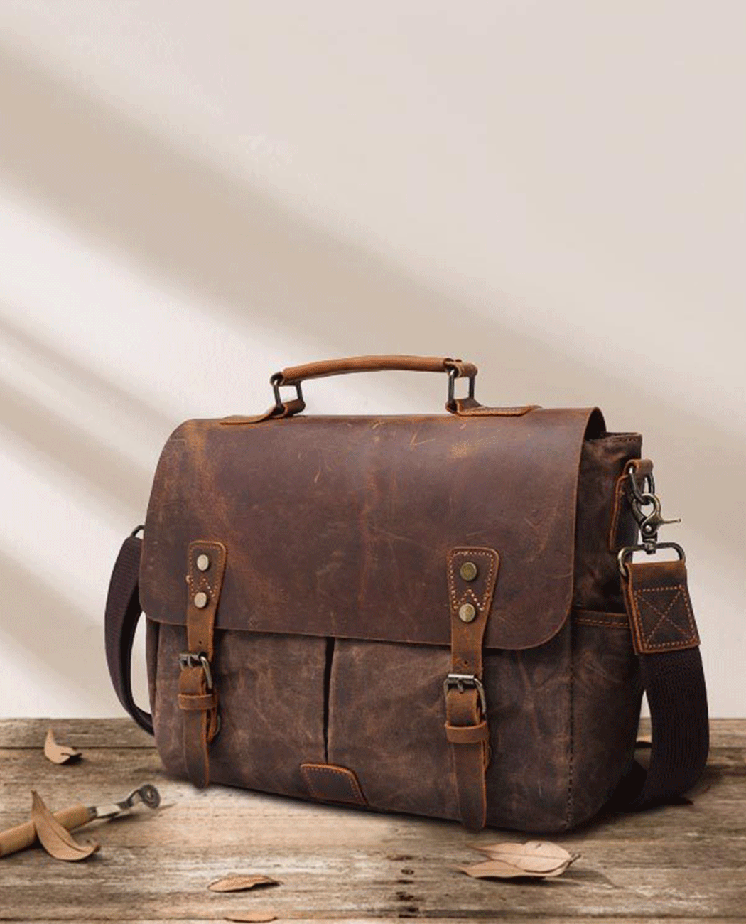Shop image of brown canvas messenger bag with leather flap